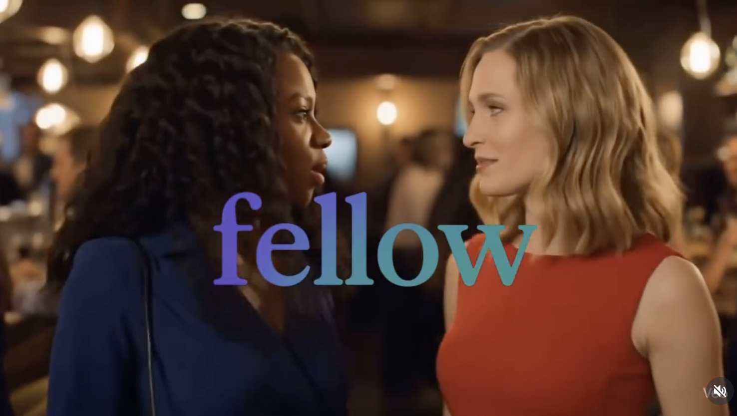 Fellow brand still: two women meeting in a warmly lit restaurant with the fellow wordmark overlaid